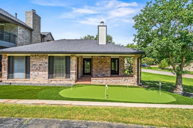 101 Fairway View Ln, Montgomery, TX 77356 - view of front of home featuring a putting area, a front yard, a porch, and a chimney
