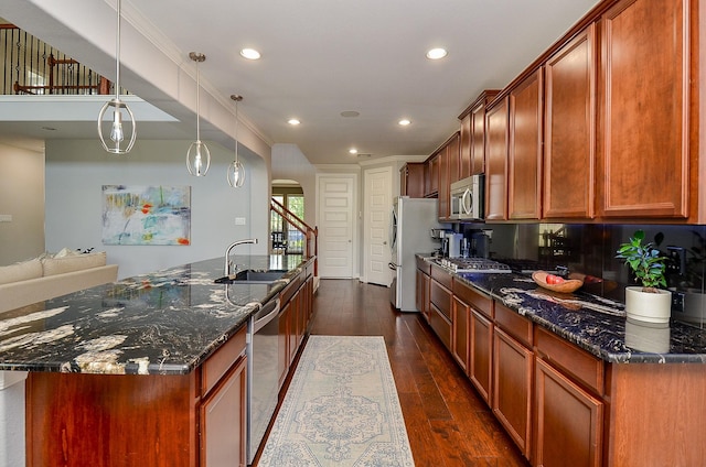25718 Creek Ledge Dr, Katy, TX 77494 - kitchen with appliances with stainless steel finishes, dark stone countertops, recessed lighting, dark wood-type flooring, and a spacious island