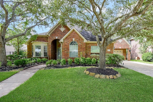 9610 Oakland Lake Way, Missouri City, TX 77459 - view of front of property featuring brick siding, a shingled roof, and concrete driveway