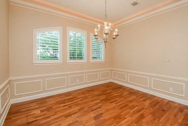 9610 Oakland Lake Way, Missouri City, TX 77459 - spare room with a chandelier, wood finished floors, a decorative wall, ornamental molding, and wainscoting