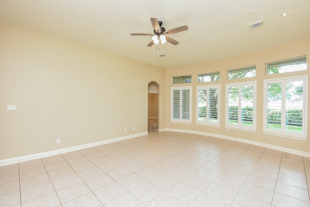 9610 Oakland Lake Way, Missouri City, TX 77459 - spare room featuring arched walkways, a ceiling fan, and light tile patterned floors