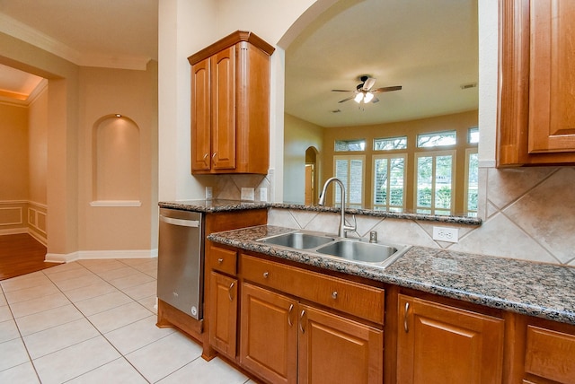 9610 Oakland Lake Way, Missouri City, TX 77459 - kitchen with stainless steel dishwasher, ceiling fan, arched walkways, brown cabinets, and ornamental molding