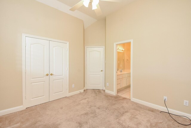 9610 Oakland Lake Way, Missouri City, TX 77459 - unfurnished bedroom with light carpet, high vaulted ceiling, a closet, connected bathroom, and ceiling fan
