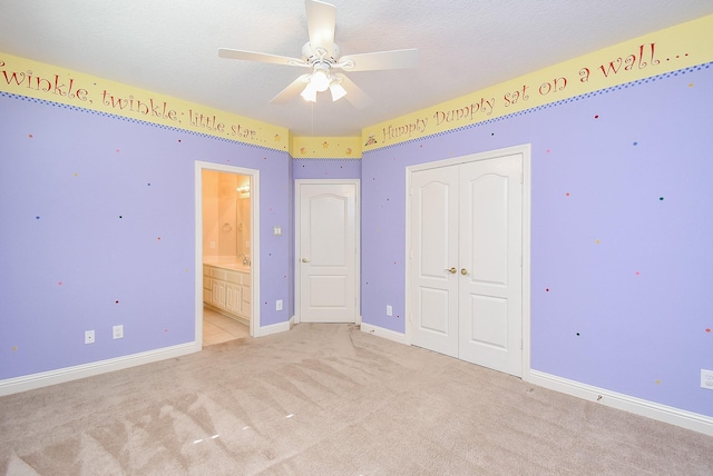 9610 Oakland Lake Way, Missouri City, TX 77459 - unfurnished bedroom featuring light colored carpet, a closet, ensuite bathroom, and a ceiling fan