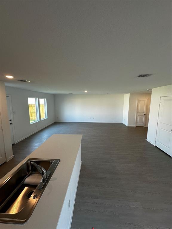 10824 Red Orchid Dr, Houston, TX 77016 - interior space with open floor plan, dark wood-style floors, and recessed lighting