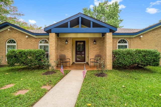 27225 Orth Ln, Conroe, TX 77385 - view of front of home featuring brick siding, a front lawn, and a porch