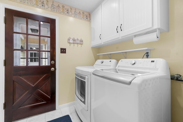 27225 Orth Ln, Conroe, TX 77385 - washroom with washing machine and dryer, cabinet space, and light tile patterned flooring