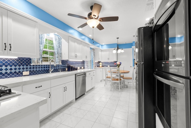 27225 Orth Ln, Conroe, TX 77385 - kitchen featuring refrigerator, stainless steel dishwasher, a ceiling fan, white cabinets, and tasteful backsplash