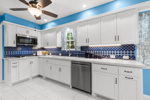 27225 Orth Ln, Conroe, TX 77385 - kitchen with appliances with stainless steel finishes, white cabinetry, decorative backsplash, ceiling fan, and recessed lighting