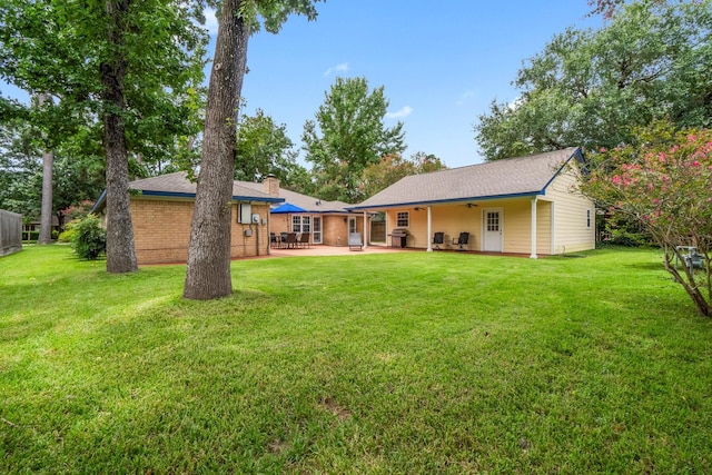 27225 Orth Ln, Conroe, TX 77385 - rear view of house featuring a patio, ceiling fan, a yard, and a chimney