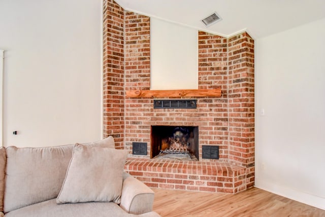 510 Daffodil St, Lake Jackson, TX 77566 - living room with wood finished floors, lofted ceiling, and a brick fireplace