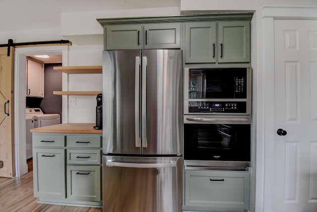 510 Daffodil St, Lake Jackson, TX 77566 - kitchen featuring stainless steel appliances, separate washer and dryer, open shelves, wooden counters, and green cabinetry