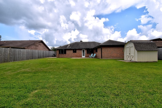 510 Daffodil St, Lake Jackson, TX 77566 - back of property featuring a storage shed, brick siding, a patio, a fenced backyard, and a shingled roof