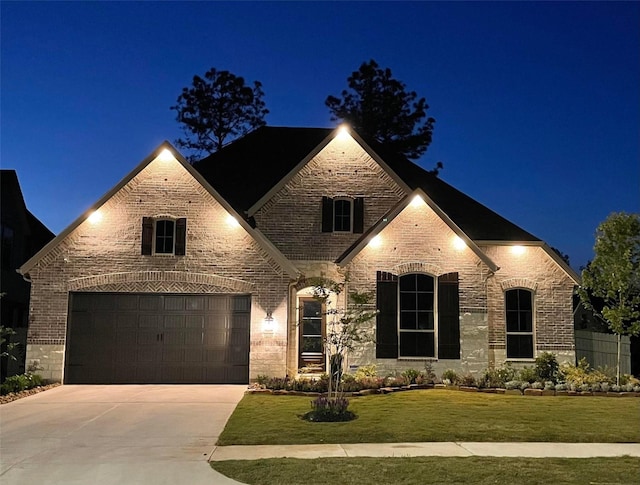 15139 Botanical Garden Dr, Conroe, TX 77302 - view of front of property featuring driveway, brick siding, a garage, and a yard