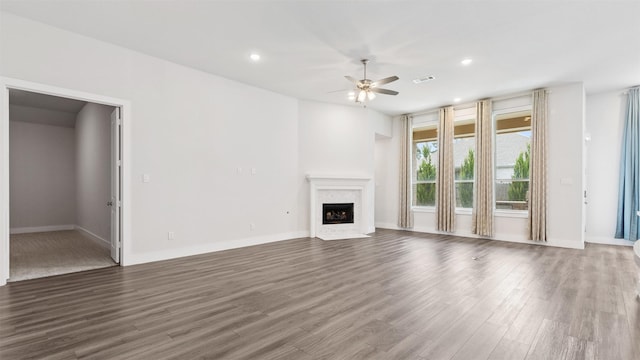 15139 Botanical Garden Dr, Conroe, TX 77302 - unfurnished living room with ceiling fan, a fireplace with flush hearth, dark wood finished floors, and recessed lighting