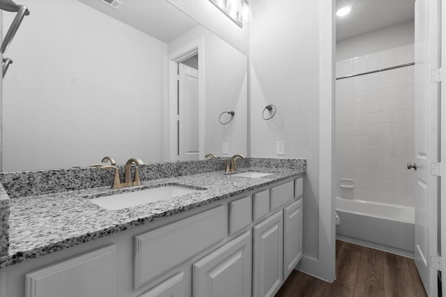 15139 Botanical Garden Dr, Conroe, TX 77302 - bathroom with double vanity, wood finished floors, shower / bathtub combination, and recessed lighting