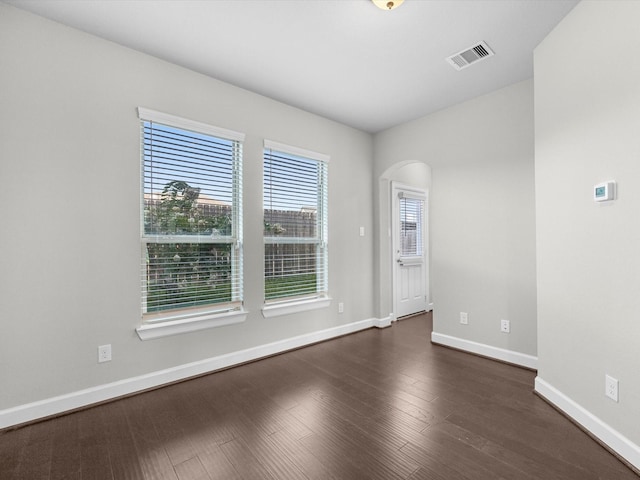 9618 Cambridge Manor Ln, Houston, TX 77045 - unfurnished room featuring dark wood-style flooring and arched walkways