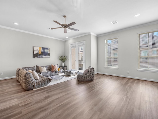 9618 Cambridge Manor Ln, Houston, TX 77045 - living room with wood finished floors, healthy amount of natural light, recessed lighting, ceiling fan, and crown molding