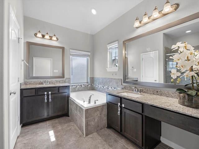 9618 Cambridge Manor Ln, Houston, TX 77045 - bathroom with a bath, two vanities, tile patterned flooring, and a stall shower