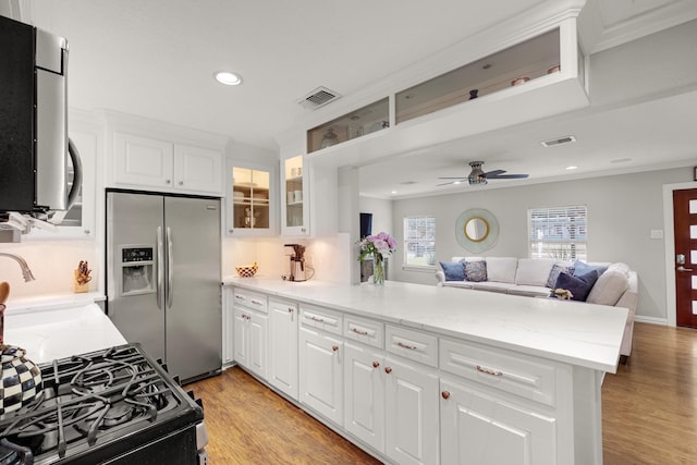 1838 Saxon Dr, Houston, TX 77018 - kitchen featuring stainless steel refrigerator with ice dispenser, a peninsula, ceiling fan, open floor plan, and recessed lighting