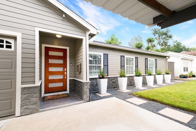 1838 Saxon Dr, Houston, TX 77018 - property entrance featuring stone siding, a patio area, and a lawn