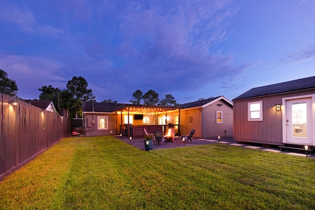 1838 Saxon Dr, Houston, TX 77018 - back of house at dusk with a fire pit, a fenced backyard, and a patio area