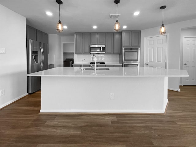 25621 Ramsey Heights Way, Porter, TX 77365 - kitchen with stainless steel appliances, gray cabinetry, light countertops, dark wood finished floors, and recessed lighting