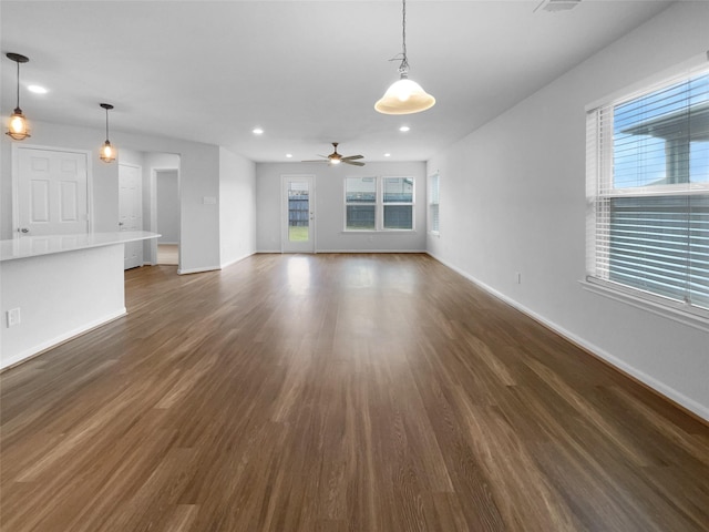 25621 Ramsey Heights Way, Porter, TX 77365 - unfurnished living room with dark wood-style flooring, recessed lighting, healthy amount of natural light, and a ceiling fan