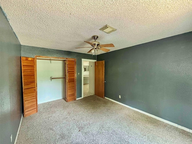 7947 Moore Dr, Pearland, TX 77584 - unfurnished bedroom featuring a closet, carpet flooring, ceiling fan, and a textured ceiling