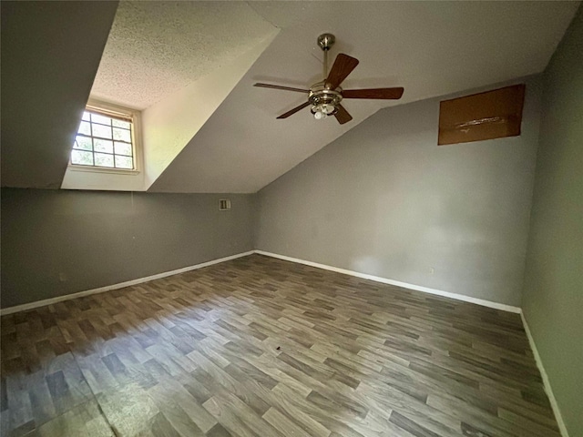 7947 Moore Dr, Pearland, TX 77584 - additional living space featuring wood finished floors, ceiling fan, vaulted ceiling, and a textured ceiling