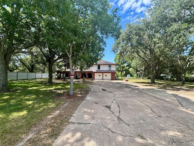 7947 Moore Dr, Pearland, TX 77584 - obstructed view of property with asphalt driveway, an attached garage, and brick siding