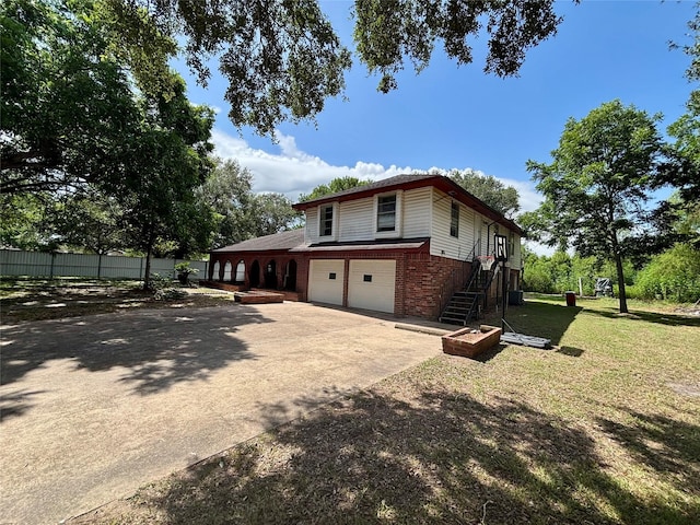 7947 Moore Dr, Pearland, TX 77584 - view of home's exterior featuring brick siding, stairs, a garage, and concrete driveway