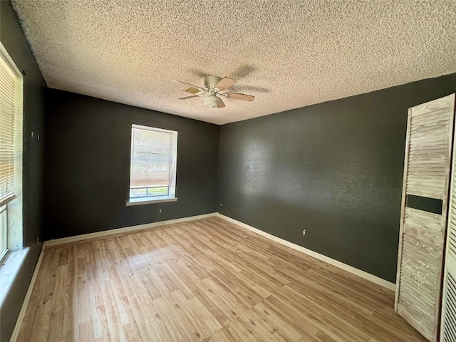 7947 Moore Dr, Pearland, TX 77584 - spare room with wood finished floors, a ceiling fan, and a textured ceiling