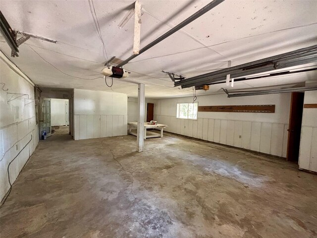 7947 Moore Dr, Pearland, TX 77584 - garage featuring a garage door opener and a wainscoted wall
