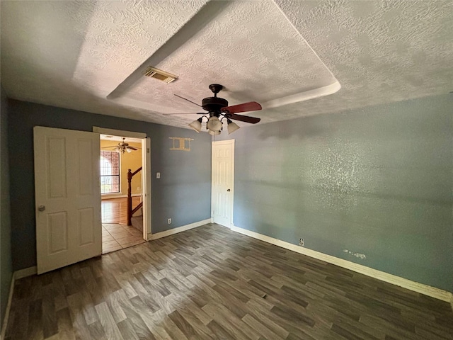 7947 Moore Dr, Pearland, TX 77584 - spare room with a textured ceiling, wood finished floors, and a ceiling fan