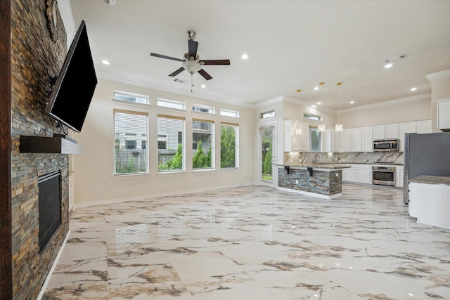 13205 Dartmoor Terrace Dr, Houston, TX 77077 - living room featuring a stone fireplace, ceiling fan, crown molding, recessed lighting, and light marble finish flooring