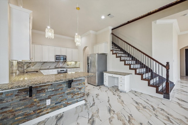 13205 Dartmoor Terrace Dr, Houston, TX 77077 - kitchen with appliances with stainless steel finishes, arched walkways, light stone counters, crown molding, and a peninsula
