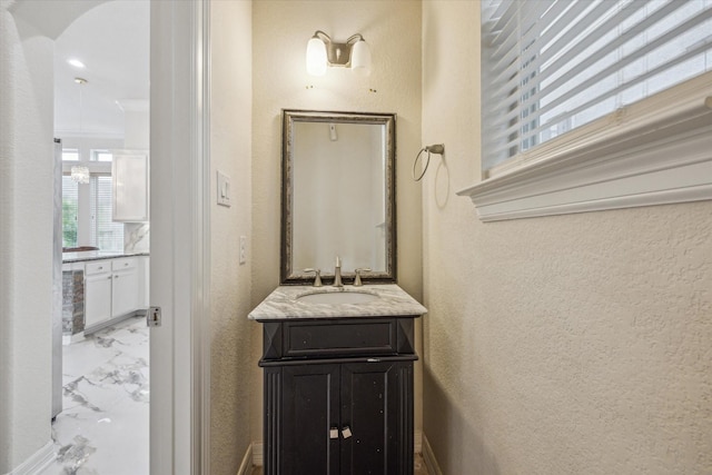 13205 Dartmoor Terrace Dr, Houston, TX 77077 - bathroom with vanity, a textured wall, and marble finish floors