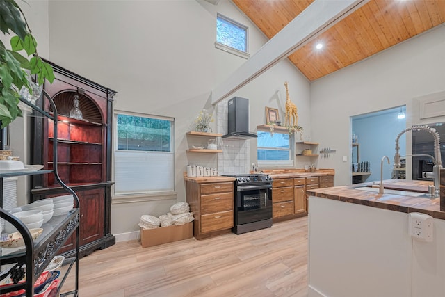 6170 Beech Dr, Montgomery, TX 77316 - kitchen featuring stainless steel electric range oven, wall chimney range hood, high vaulted ceiling, open shelves, and light wood-style flooring