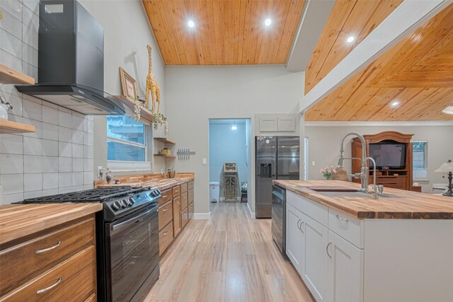 6170 Beech Dr, Montgomery, TX 77316 - kitchen with wood counters, gas range, open shelves, exhaust hood, and wood ceiling
