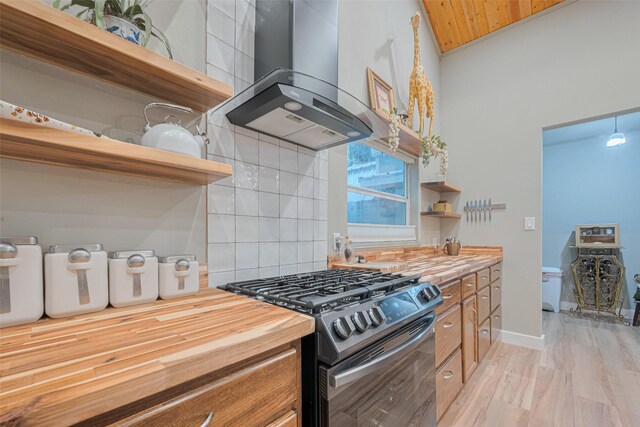 6170 Beech Dr, Montgomery, TX 77316 - kitchen featuring open shelves, range with gas cooktop, wall chimney range hood, tasteful backsplash, and wooden counters