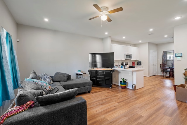 7921 Sparta St, Houston, TX 77028 - living room featuring light wood-type flooring, a ceiling fan, and recessed lighting