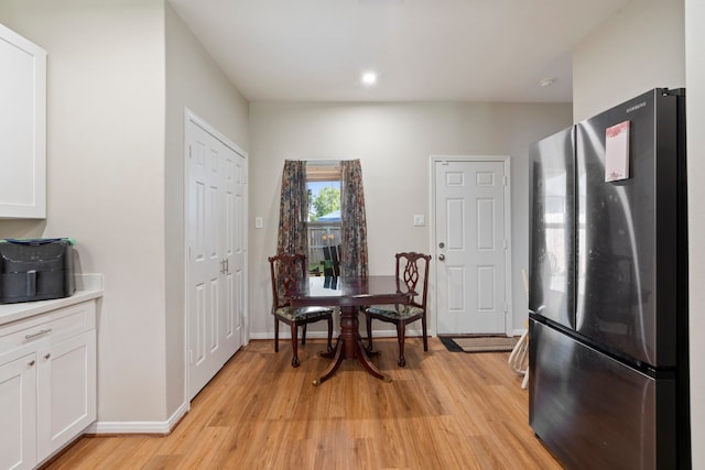 7921 Sparta St, Houston, TX 77028 - kitchen featuring freestanding refrigerator, light wood finished floors, white cabinetry, light countertops, and recessed lighting
