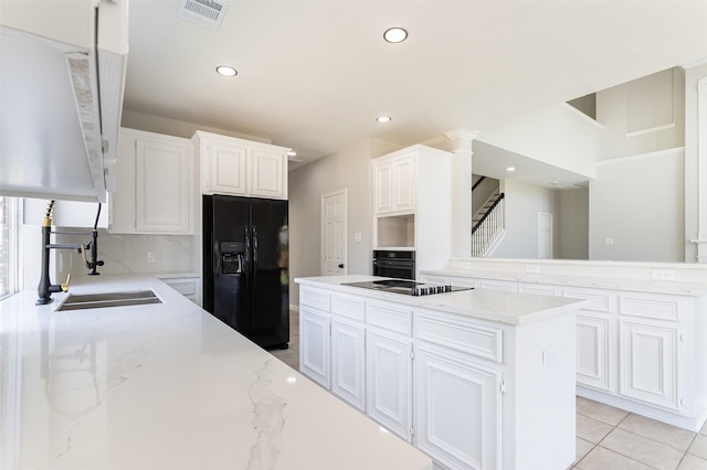 7147 Hot Creek Trce, Humble, TX 77346 - kitchen featuring black appliances, white cabinetry, light stone counters, recessed lighting, and tasteful backsplash