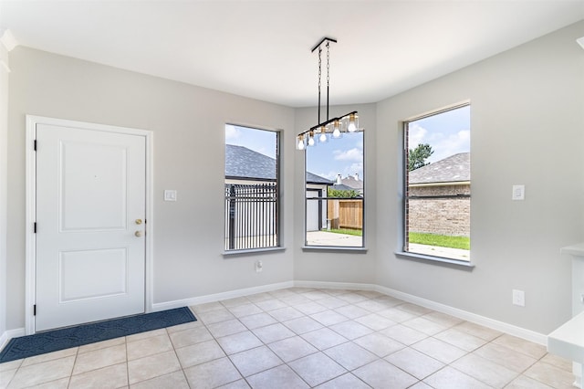 7147 Hot Creek Trce, Humble, TX 77346 - unfurnished dining area featuring plenty of natural light and light tile patterned floors