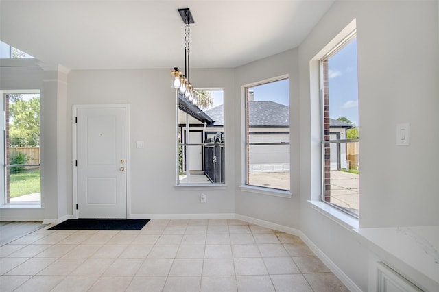 7147 Hot Creek Trce, Humble, TX 77346 - unfurnished dining area with healthy amount of natural light and light tile patterned floors