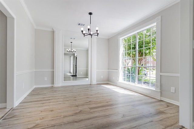7147 Hot Creek Trce, Humble, TX 77346 - unfurnished dining area featuring a chandelier, ornamental molding, healthy amount of natural light, and light wood finished floors