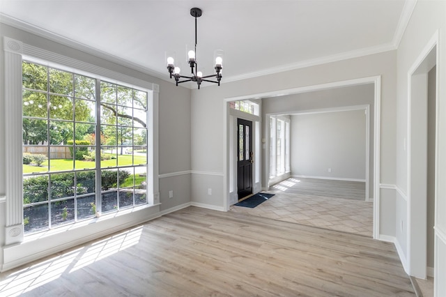 7147 Hot Creek Trce, Humble, TX 77346 - unfurnished dining area featuring a chandelier, crown molding, and light wood-style floors