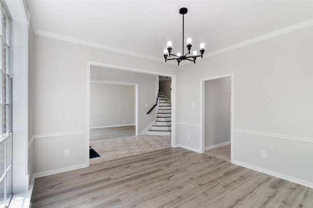 7147 Hot Creek Trce, Humble, TX 77346 - unfurnished room featuring a chandelier, stairway, wood finished floors, and crown molding