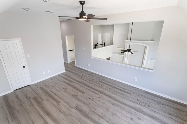 7147 Hot Creek Trce, Humble, TX 77346 - unfurnished living room with a ceiling fan, wood finished floors, and vaulted ceiling